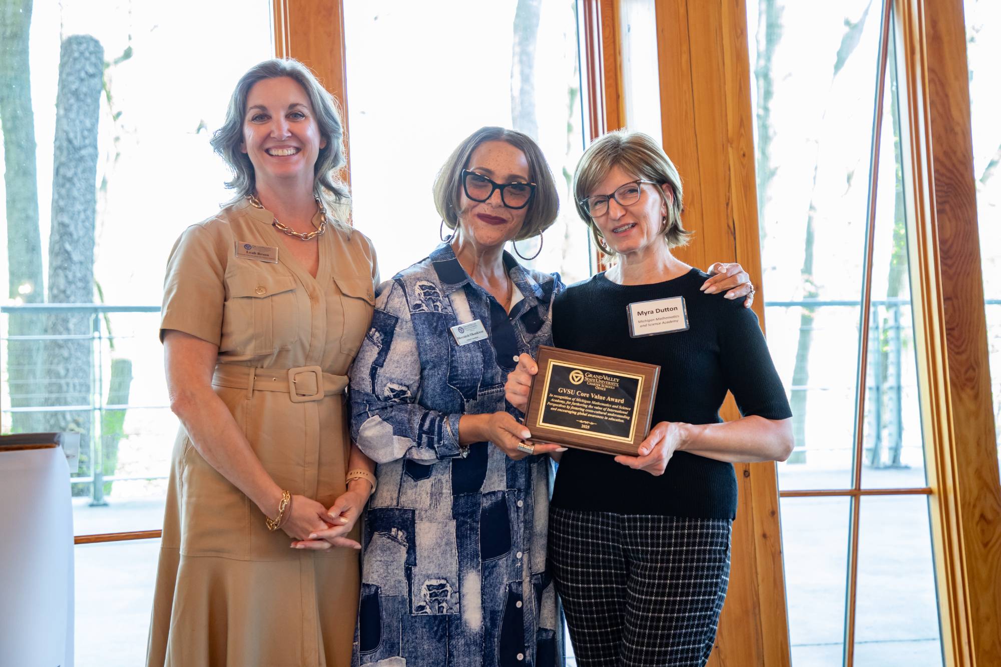 A board member from Michigan Math and Science Academy accepting the award from the CSO's Merrideth Okonkwor